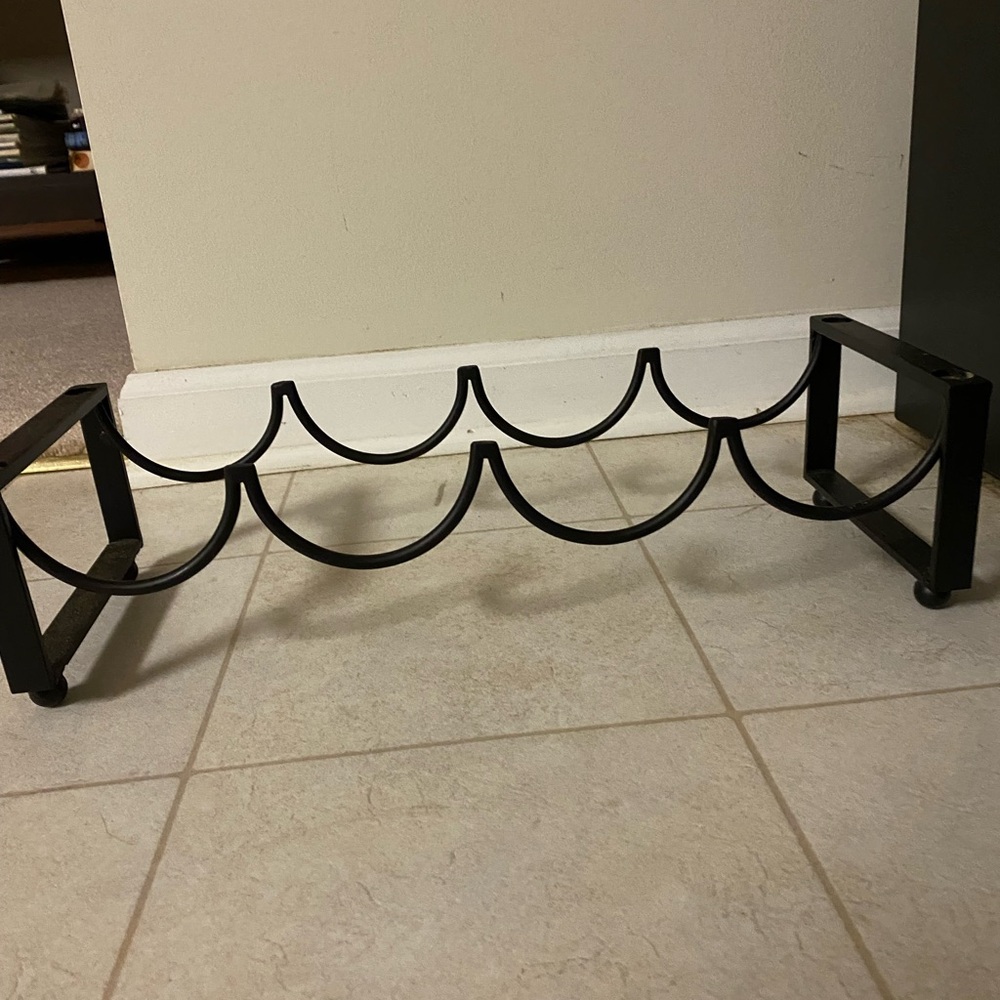 Stackable wine rack . Black wrought iron .